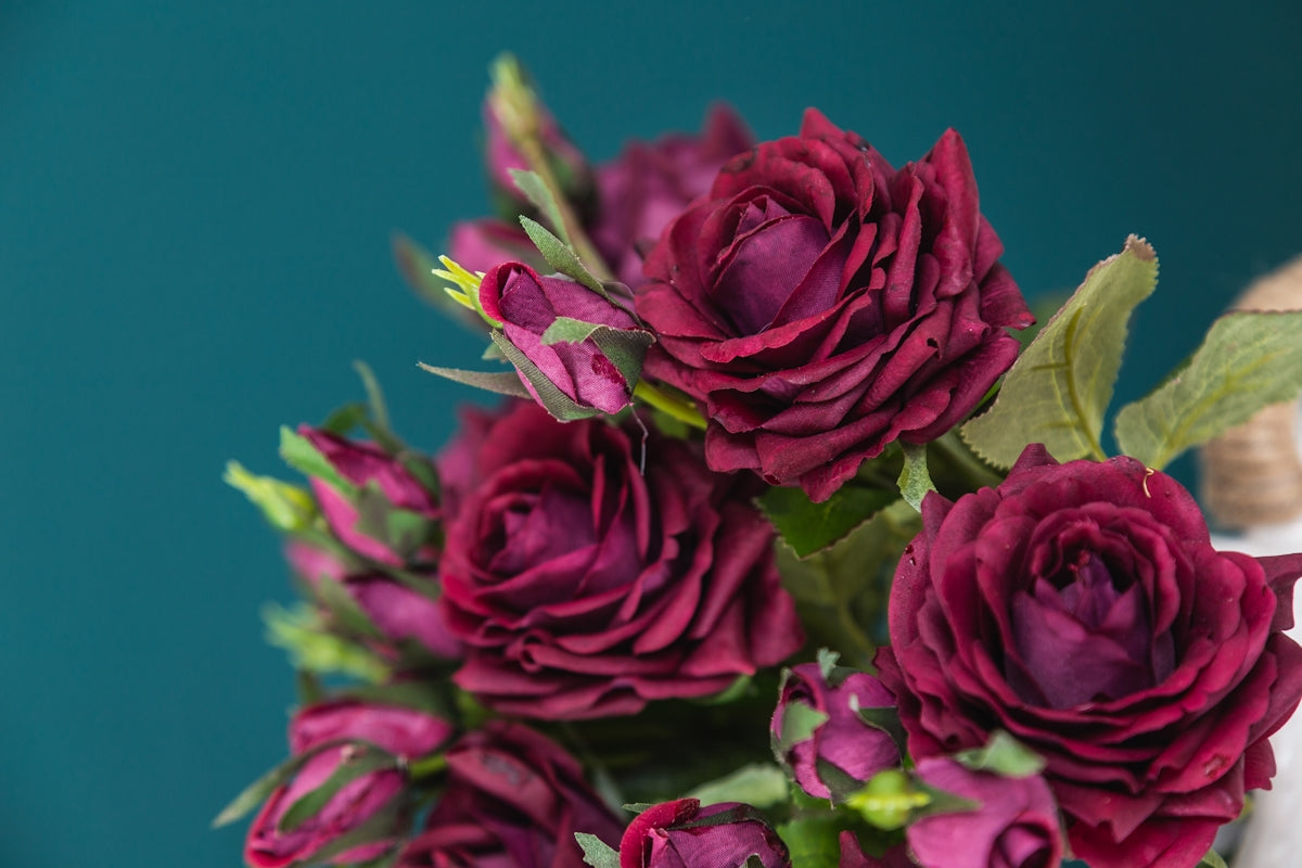 a vase filled with purple flowers on top of a table